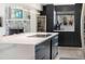 Modern kitchen features marble counters, stainless steel appliances and a large kitchen island at 7591 S Reed Ct, Littleton, CO 80128
