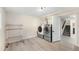Bright laundry room featuring modern washer and dryer and storage at 7591 S Reed Ct, Littleton, CO 80128