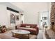 Cozy living room with a stone fireplace, comfortable sofa, and stylish decor at 7591 S Reed Ct, Littleton, CO 80128