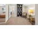Cozy living area with neutral carpet, bookshelf, and comfortable seating arrangement at 7591 S Reed Ct, Littleton, CO 80128