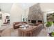Bright living room with a stone fireplace, high ceilings, comfortable sofas, and natural light at 7591 S Reed Ct, Littleton, CO 80128
