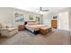 Tranquil main bedroom with a ceiling fan, neutral tones, and ample natural light at 7591 S Reed Ct, Littleton, CO 80128