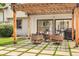 Inviting outdoor patio with pergola, stylish seating, and a fire pit, ideal for relaxing and entertaining guests at 7591 S Reed Ct, Littleton, CO 80128