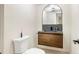 Modern powder room with unique vanity, lighting and wall mirror at 7591 S Reed Ct, Littleton, CO 80128