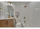 Bathroom features white tiled walls, updated vanity, new shower, and modern fixtures at 3243 S Vrain St, Denver, CO 80236