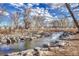 Beautiful stream with clear water flowing over rocks, surrounded by trees and vegetation, creating a serene natural setting at 3243 S Vrain St, Denver, CO 80236