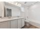 Bathroom with double vanity, modern lighting, and combined shower and bath at 9692 Cathay St, Commerce City, CO 80022