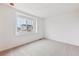 Bright bedroom featuring plush carpeting, a large window, and ample natural light at 9692 Cathay St, Commerce City, CO 80022