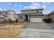 Charming two-story home with gray siding, stone accents, and a well-maintained front yard at 9692 Cathay St, Commerce City, CO 80022