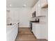 A modern kitchen with stainless steel appliances, white cabinetry, and countertops at 9692 Cathay St, Commerce City, CO 80022