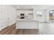 Well-lit kitchen with white cabinets, stainless steel appliances, and a center island at 9692 Cathay St, Commerce City, CO 80022