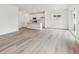 Open-concept living area with kitchen, island, and bright light wood floors at 9692 Cathay St, Commerce City, CO 80022
