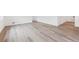 Spacious living room featuring modern light wood floors, bright natural light, and open space at 9692 Cathay St, Commerce City, CO 80022