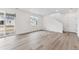 Open-concept living area with wood floors, sliding glass doors, and ample natural light at 9692 Cathay St, Commerce City, CO 80022