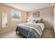 Well-lit bedroom featuring window with tree view and queen sized bed at 9031 E Amherst Dr # D, Denver, CO 80231