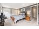 Charming bedroom featuring soft gray walls, carpet and ample closet space at 9031 E Amherst Dr # D, Denver, CO 80231