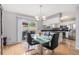 Contemporary dining area featuring a glass table and sliding door to the patio at 9031 E Amherst Dr # D, Denver, CO 80231