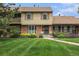 Charming townhome with a well-manicured lawn and inviting brick facade at 9031 E Amherst Dr # D, Denver, CO 80231