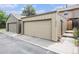 View of the garage with painted door and matching siding at 9031 E Amherst Dr # D, Denver, CO 80231