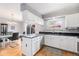 Modern kitchen with granite countertops, stainless steel appliances, and dining area at 9031 E Amherst Dr # D, Denver, CO 80231