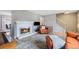 Inviting living room with a cozy fireplace, neutral colors and hardwood flooring at 9031 E Amherst Dr # D, Denver, CO 80231