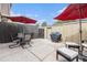 Private patio with outdoor seating, a grill, and two red umbrellas at 9031 E Amherst Dr # D, Denver, CO 80231