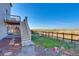 Backyard with view, deck, and stairs leading down to the fenced-in yard at 9373 Pitkin St, Commerce City, CO 80022