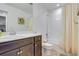 Bathroom featuring dark vanity with white countertop and shower-tub combo with curtain at 9373 Pitkin St, Commerce City, CO 80022