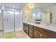 Modern bathroom with glass shower, double vanity, and tile floors, perfect for families at 9373 Pitkin St, Commerce City, CO 80022