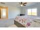 Bedroom with a floral patterned bedspread, study desk, and large window at 9373 Pitkin St, Commerce City, CO 80022