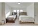Bedroom with two twin beds, plush carpet, and neutral walls at 9373 Pitkin St, Commerce City, CO 80022