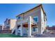 Two-story home with a deck, backyard, and light-colored siding at 9373 Pitkin St, Commerce City, CO 80022