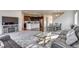 Open-concept living room with modern furnishings, flowing into a spacious kitchen and dining area at 9373 Pitkin St, Commerce City, CO 80022
