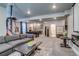 Open-concept basement includes a sectional sofa, a pool table, a kitchenette, and a bathroom at 16578 E 111Th Pl, Commerce City, CO 80022