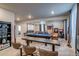 Finished basement includes a seating area, a pool table, theater screen, and games at 16578 E 111Th Pl, Commerce City, CO 80022