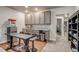 Basement kitchenette with seating, gray cabinetry, granite countertops, and stainless steel appliances at 16578 E 111Th Pl, Commerce City, CO 80022