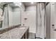 Bright bathroom featuring a granite countertop and tile shower at 16578 E 111Th Pl, Commerce City, CO 80022