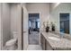 Bathroom with granite countertop, tile floor, and doorway leading to living area at 16578 E 111Th Pl, Commerce City, CO 80022