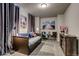 Comfortable bedroom with a pull-out bed, two chairs, and scenic wall art at 16578 E 111Th Pl, Commerce City, CO 80022