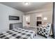 Bedroom with checkered furniture, gray walls, and two doorways leading to other rooms at 16578 E 111Th Pl, Commerce City, CO 80022
