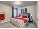 Inviting bedroom with a padded headboard, decorative poster, and stylish red accents at 16578 E 111Th Pl, Commerce City, CO 80022