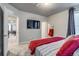 Bedroom features a gray accent wall, a television, and gray curtains at 16578 E 111Th Pl, Commerce City, CO 80022