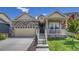 Charming single Gathering home with a stone facade, two car garage, and a cozy front porch with beautiful landscaping at 16578 E 111Th Pl, Commerce City, CO 80022