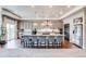 Spacious kitchen with granite island, pendant lights, gray cabinets and stainless steel refrigerator at 16578 E 111Th Pl, Commerce City, CO 80022