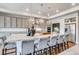 Spacious kitchen featuring a large granite island with seating, pendant lights, and stainless steel appliances at 16578 E 111Th Pl, Commerce City, CO 80022