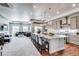Open concept kitchen with a large granite island, pendant lighting, stainless steel appliances and gray cabinets at 16578 E 111Th Pl, Commerce City, CO 80022