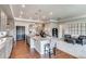 Open concept kitchen with large island, stainless steel appliances, granite countertops and view into living room at 16578 E 111Th Pl, Commerce City, CO 80022