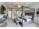 Spacious bedroom suite featuring a four-poster bed, bench, and a stylish decor at 16578 E 111Th Pl, Commerce City, CO 80022