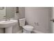 Clean powder room features a pedestal sink, toilet, and neutral-toned walls at 16578 E 111Th Pl, Commerce City, CO 80022
