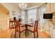 Bright breakfast nook with a chandelier, hardwood floors, and an abundance of natural light at 7759 Lee St, Arvada, CO 80005